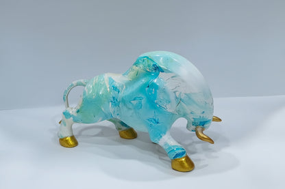 Decorative figurine of a bull with blue and white design on a white background