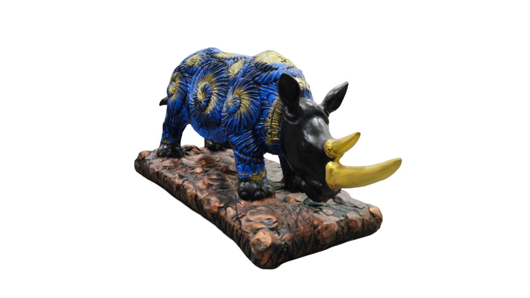 Decorative rhinoceros figurine with blue and yellow patterns on a brown base.