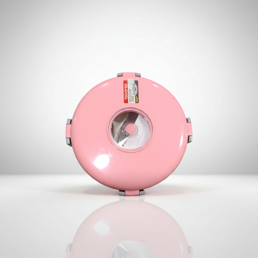 A pink round steel lunch box with a plastic spoon and a small box for sauces/vegetables.