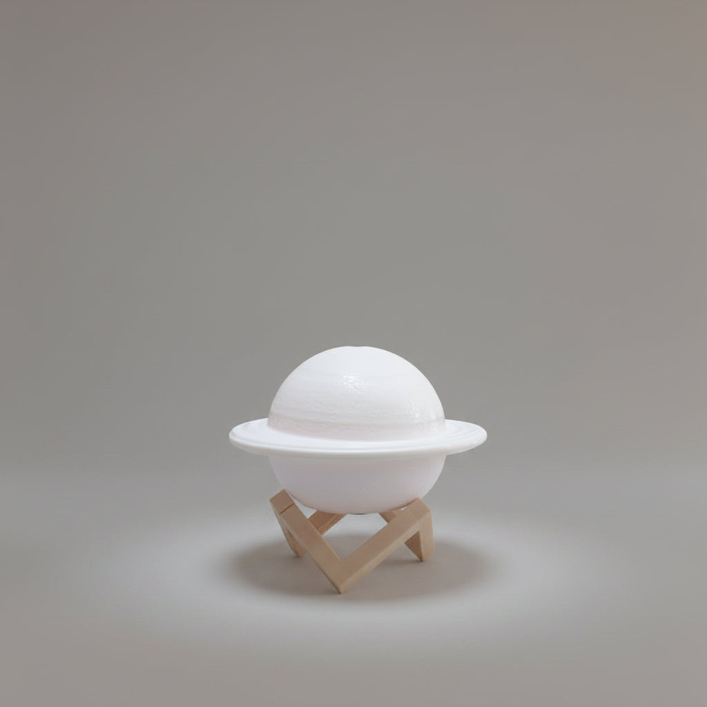 Model of Saturn on a stand against a white background