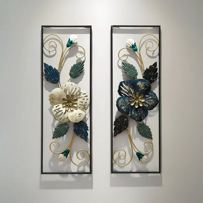 A set of two decorative metal floral wall decor pieces with a black frame, displayed on a white wall. The floral patterns are colorful and intricate, designed to add a touch of elegance and nature to any room.