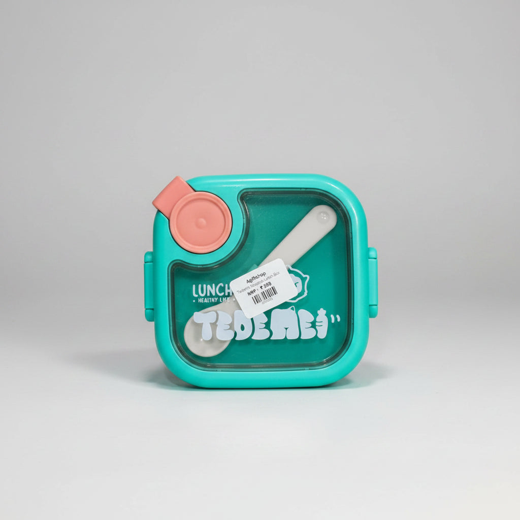 A stainless steel lunch box with a transparent lid and a pink snap closure, labeled for kids with a spoon included.