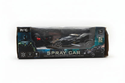 Packaged 'Batman Spray car' toy in a clear plastic box with a Batman figure and a black car toy visible inside. The box has 'age 3 and up' and '6 years and up' labels, indicating suitable for kids.