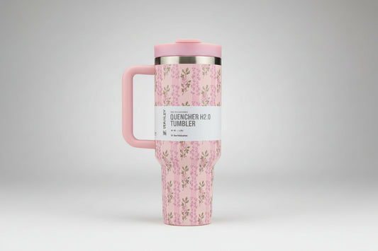 Pink floral-patterned tumbler with a handle on a white background