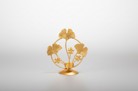Gold decorative item with leaf design on a white background