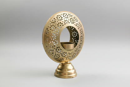Decorative gold candle holder with intricate design on a white background