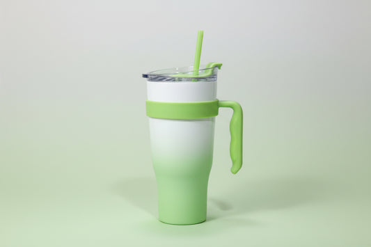 Green and white travel mug on a white background