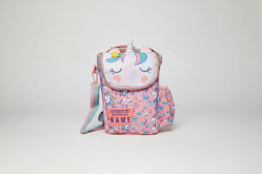 A pink insulated lunch bag featuring a unicorn face and various colorful patterns, with a customizable name option.