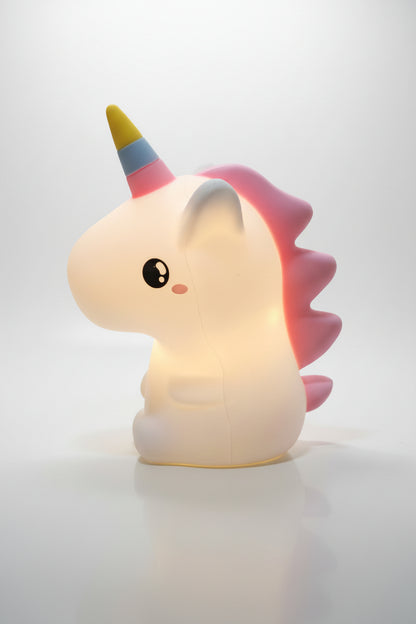 A multicolored unicorn-shaped night light glowing in a dark setting, designed for children's bedrooms.