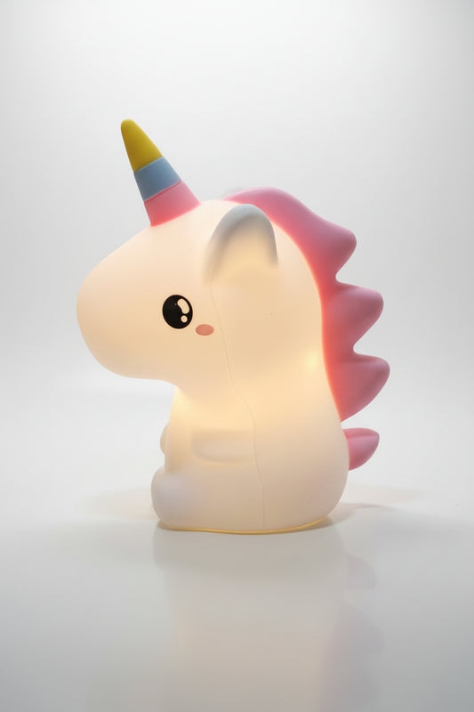A multicolored unicorn-shaped night light glowing in a dark setting, designed for children's bedrooms.