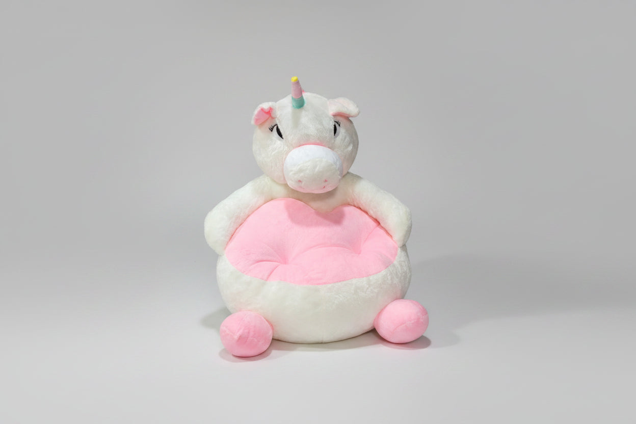 A pink and white plush sofa seat with a cartoon unicorn design suitable for children.