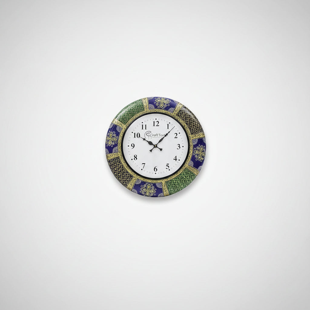 A wall clock with a handcrafted floral design, featuring a white clock face with black numerals, placed above a white sofa in a bright room.
