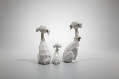 Three stone sculptures of dogs on a gray background