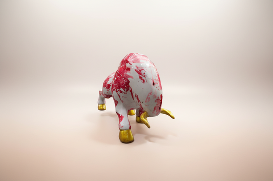 Marble-patterned toy bull with gold hooves on a white background